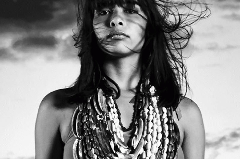 b/w photo of woman with beaded necklaces