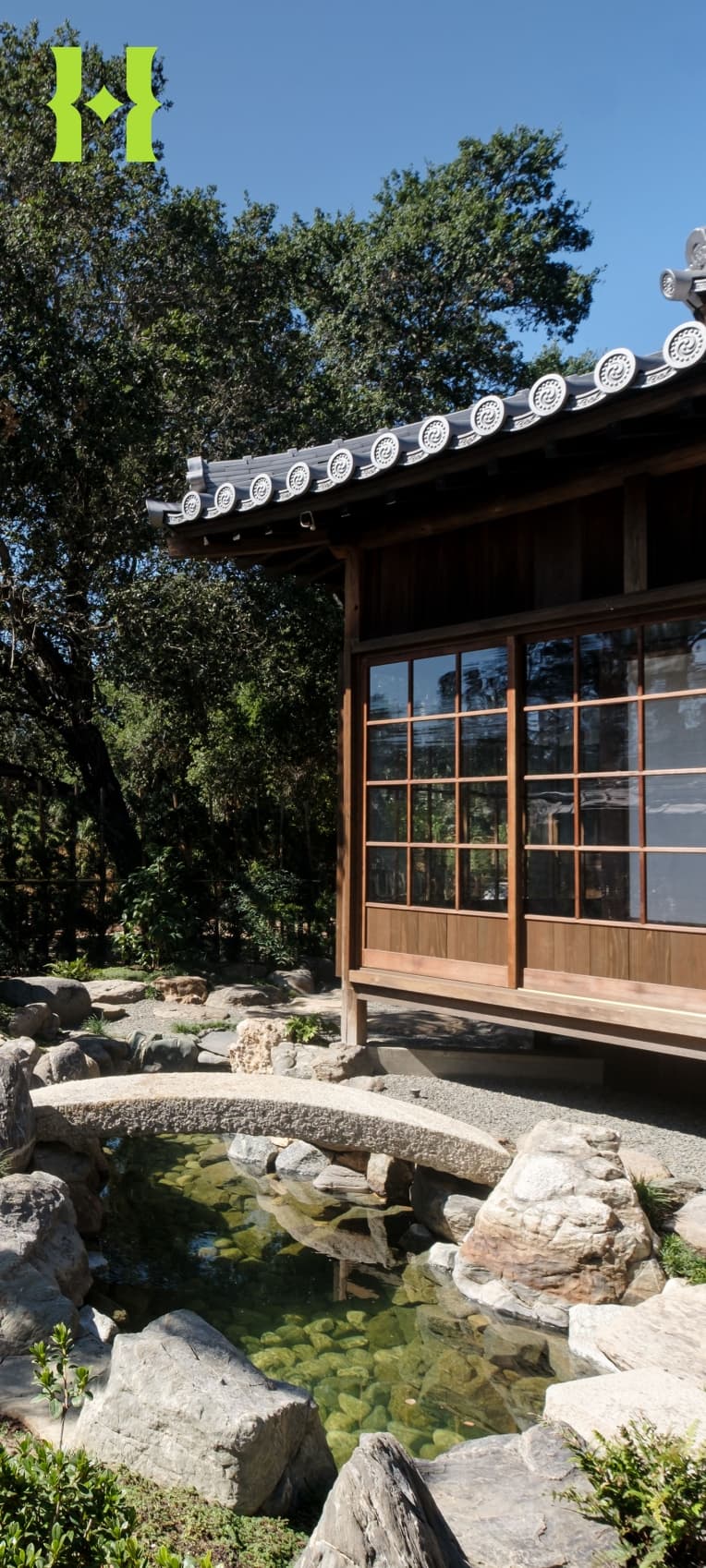 The exterior of a Japanese-style home in a garden.