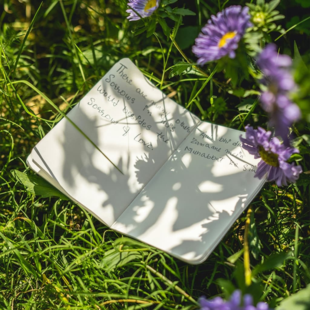 An open journal in a garden.