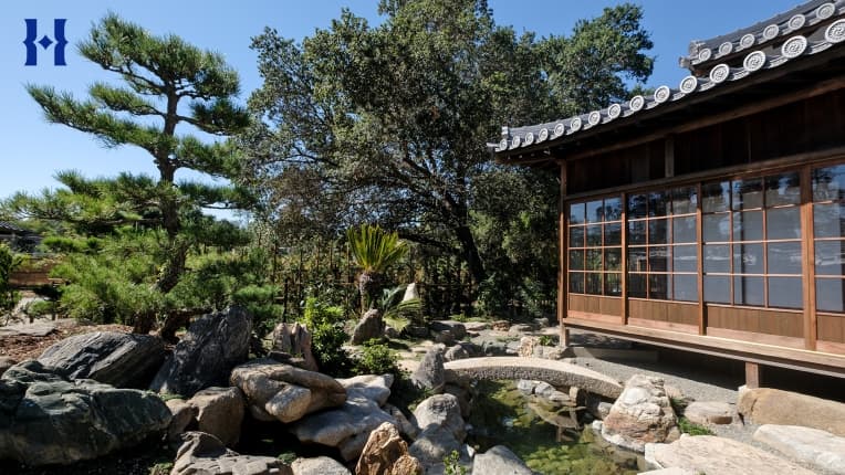 A Japanese-style home in a garden.