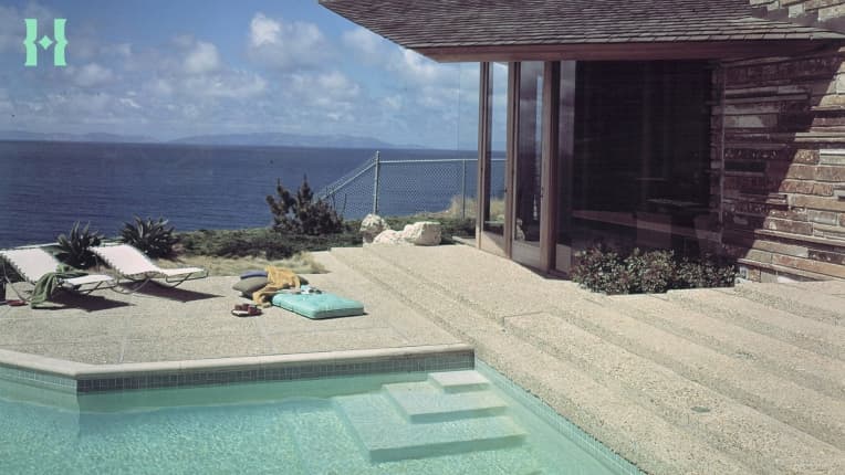 A pool at a home near the ocean.